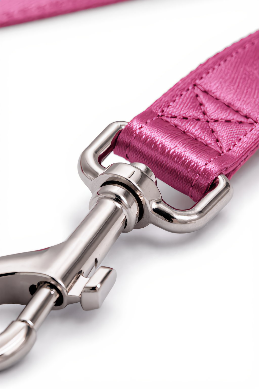 Close-up of a pink leather strap with a silver buckle on a white background