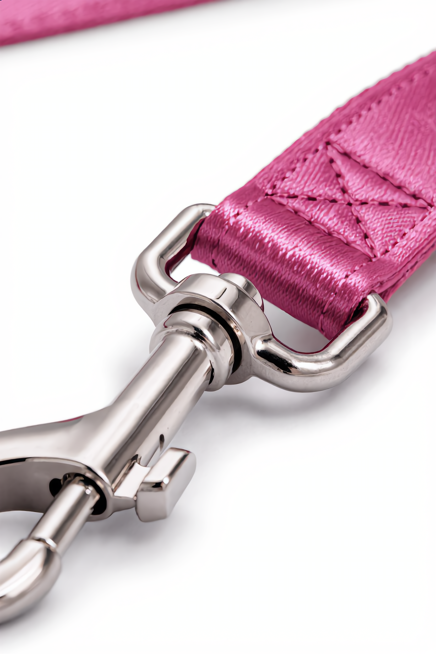 Close-up of a pink leather strap with a silver buckle on a white background