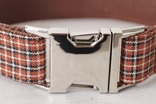 Plaid dog collar with a metal buckle on a white background