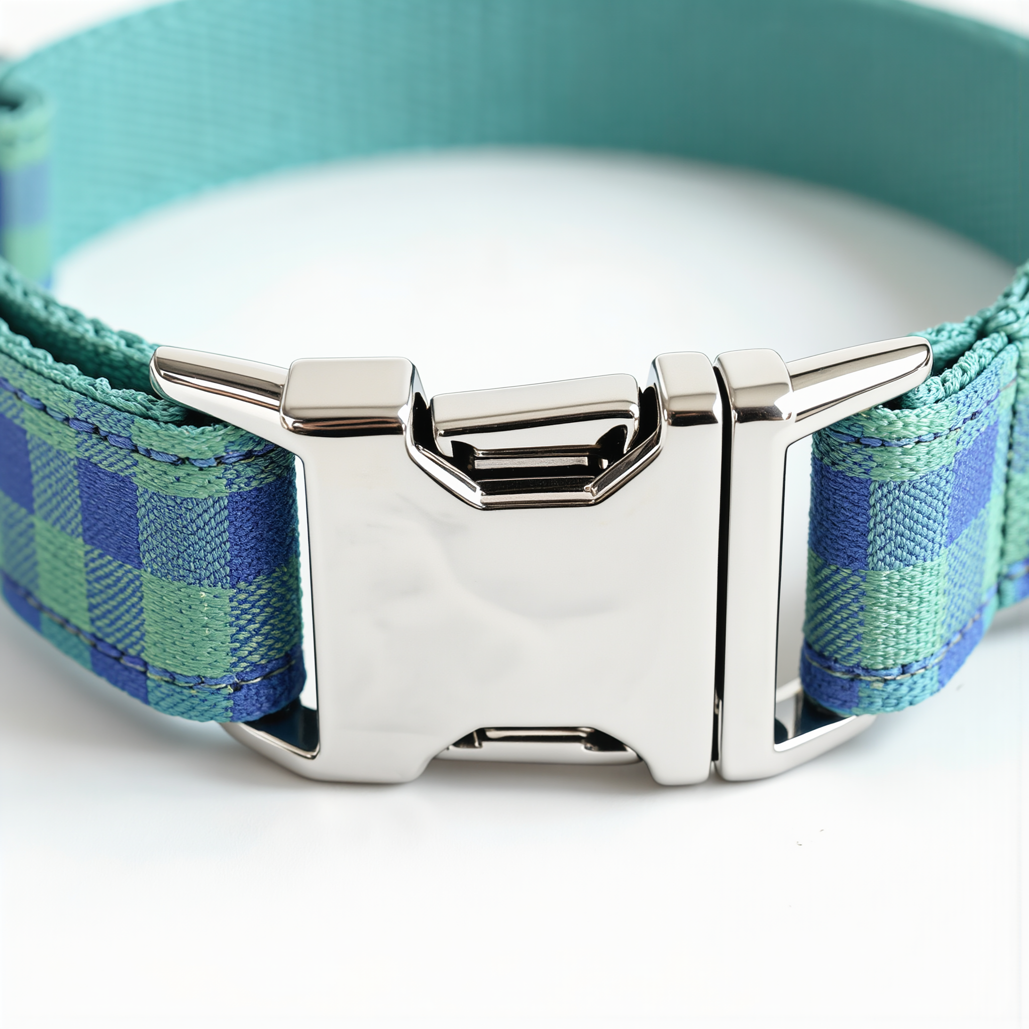 Blue and green plaid dog collar with a silver buckle on a white background